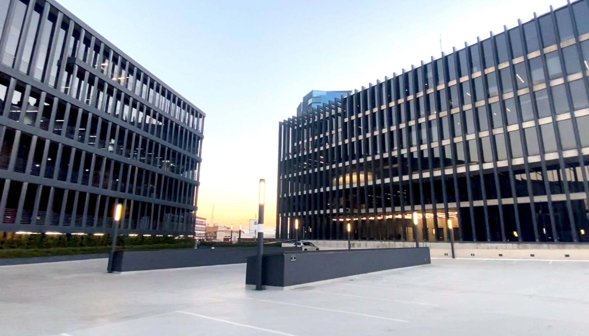 a building with windows and a parking lot
