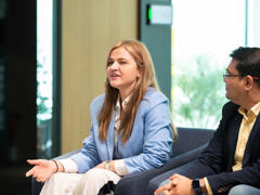a woman sitting in a chair with a man in a suit