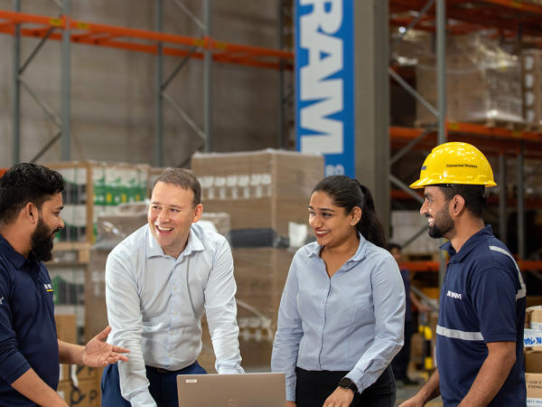 Four Associates Meeting In A Warehouse