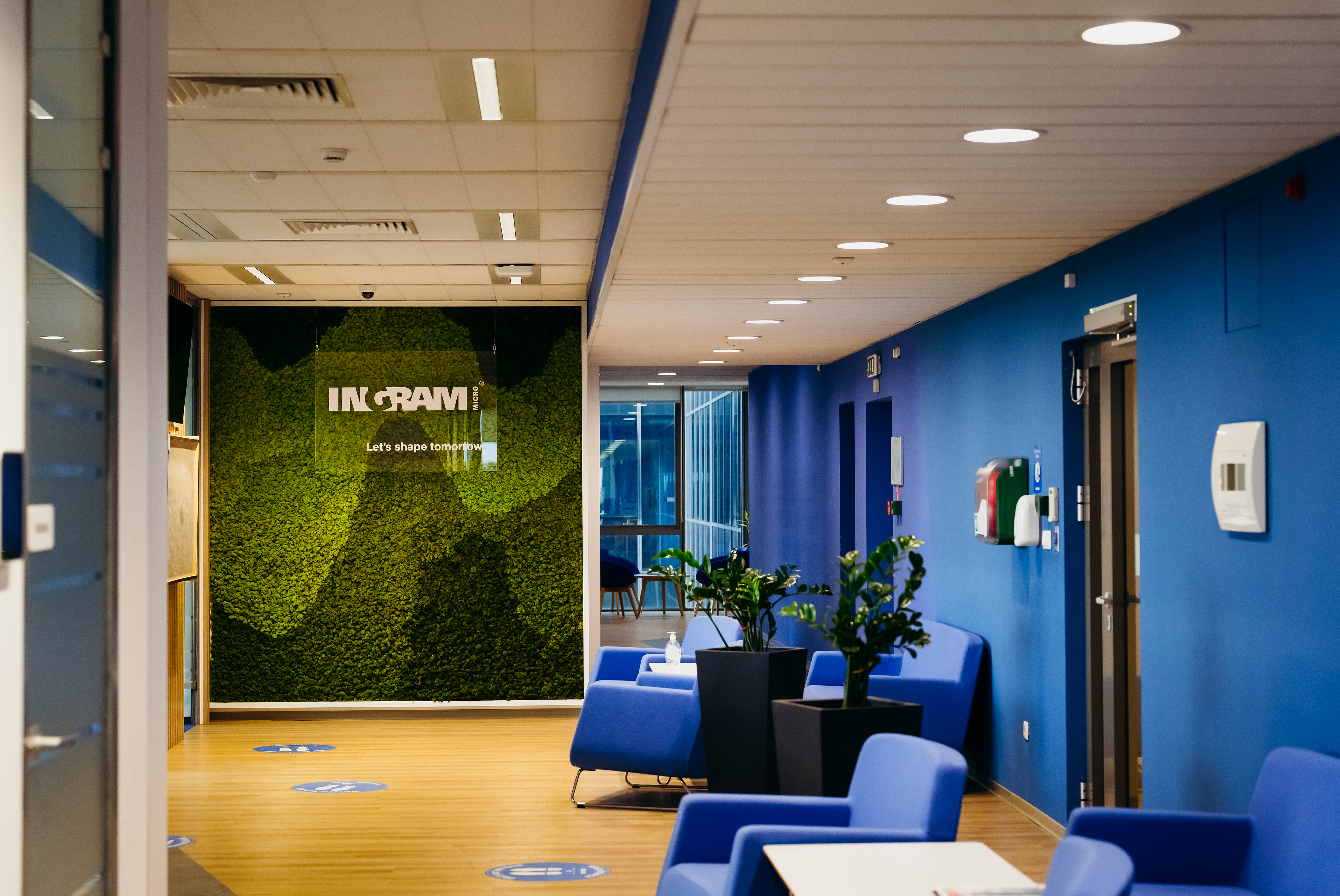 a blue room with blue chairs and a green wall