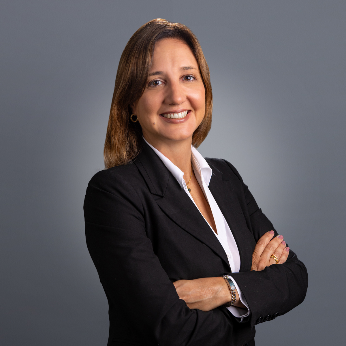 a person in a suit with her arms crossed