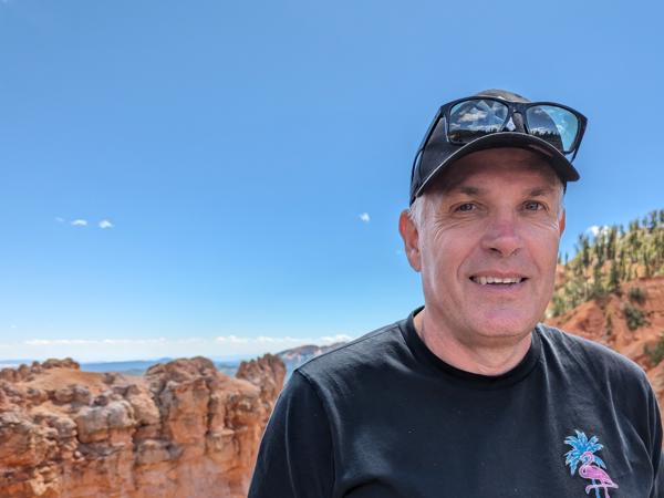 a person standing in front of a rock formation