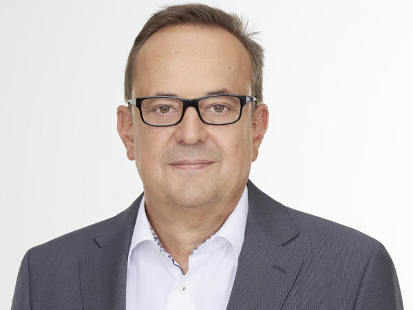 a person wearing glasses and a suit