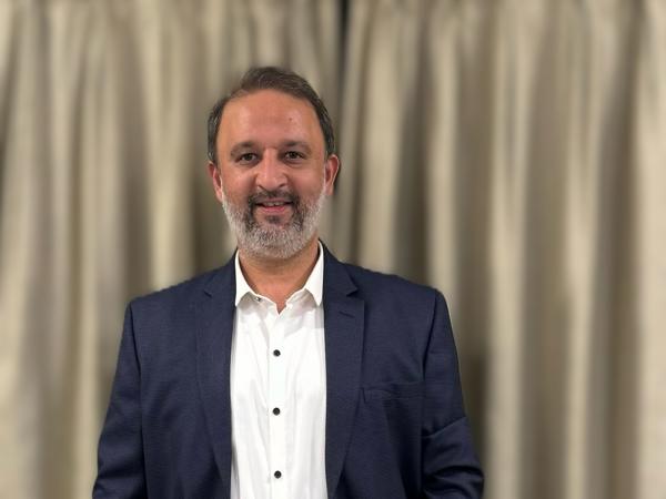 a person standing in front of a curtain