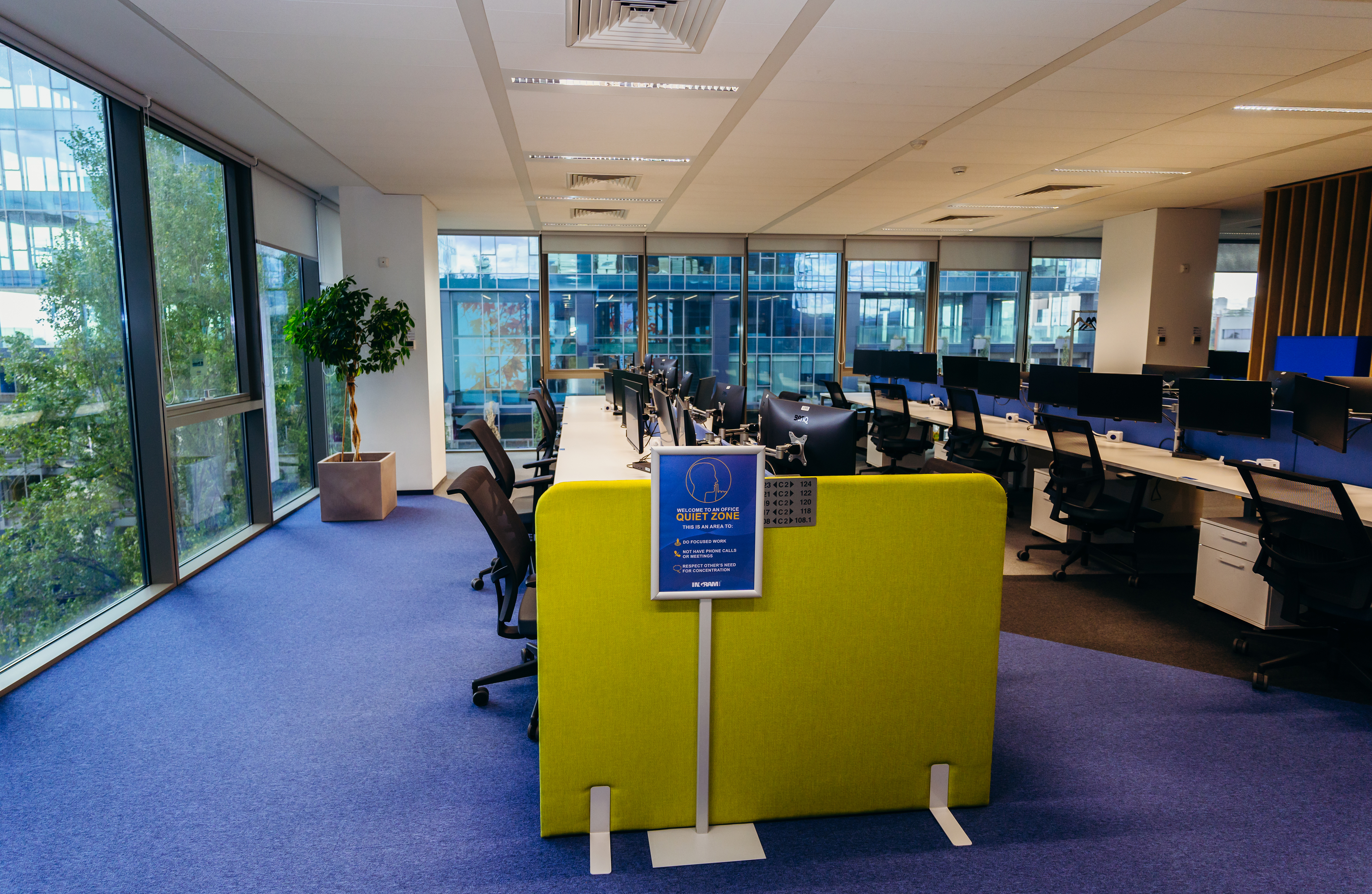 a room with a yellow wall and chairs