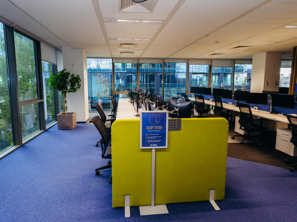a room with a yellow wall and chairs