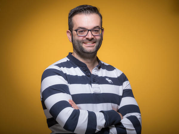 a person with glasses smiling