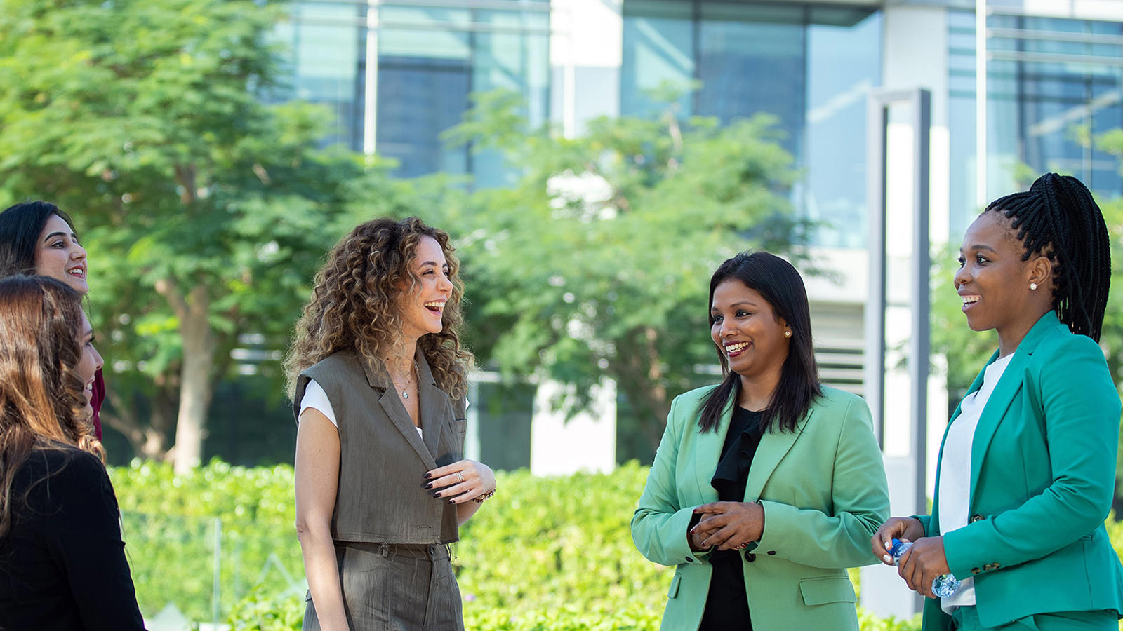 Five Female Associates Speaking Outside The Office