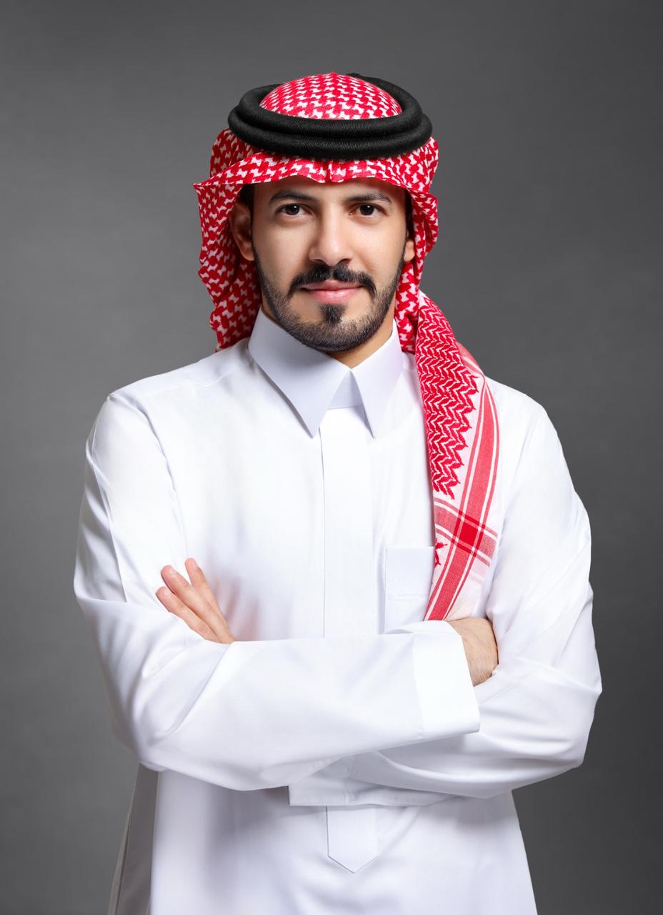 a person with a beard and a red and white headdress