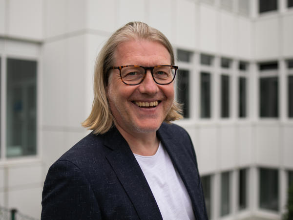 a person wearing glasses and a suit