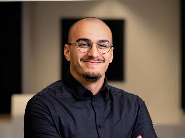 a person wearing glasses and a black shirt