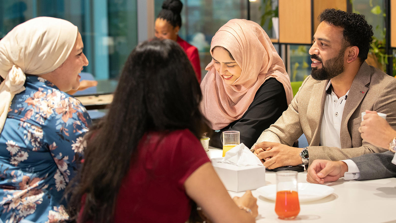 a group of people sitting around a table