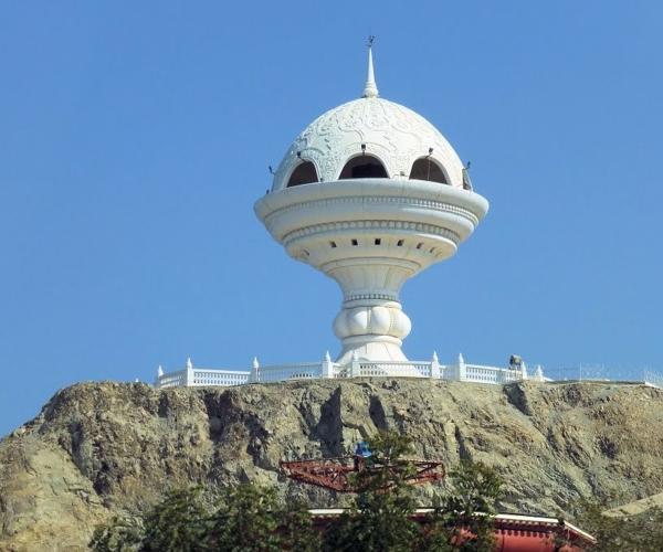 a white round structure on a hill