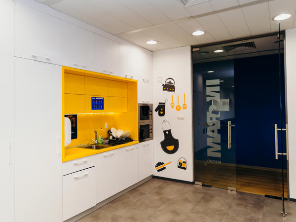 a white and yellow kitchen with a glass door