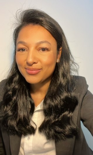 a person with long hair smiling