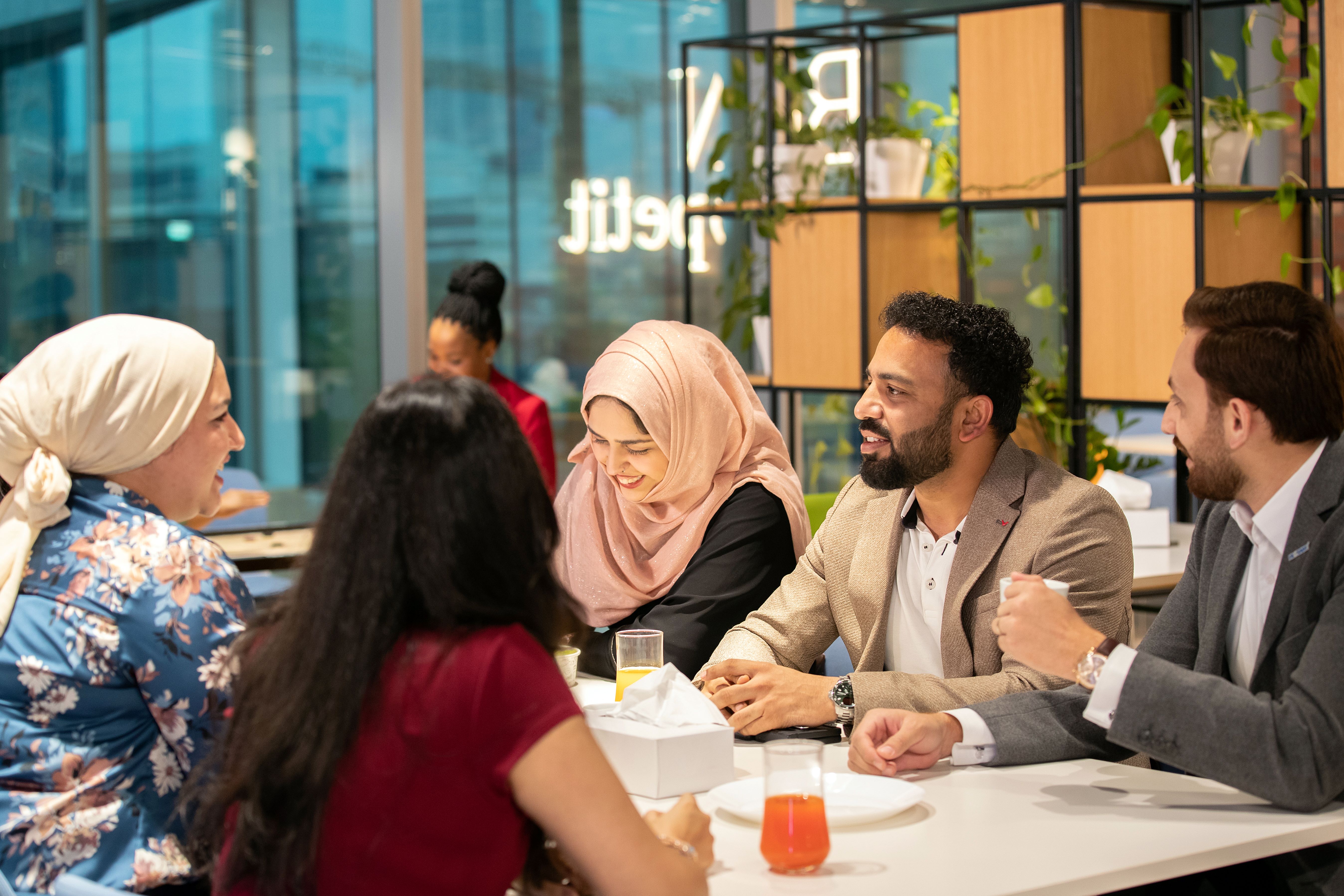 a group of people sitting around a table