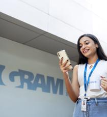 a person holding a phone and a mug