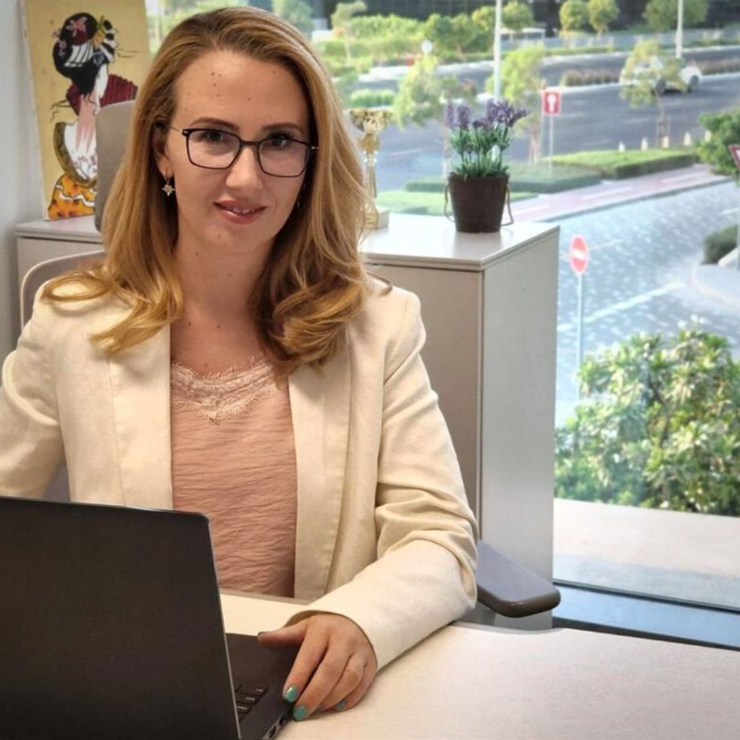 a person sitting at a desk with a laptop