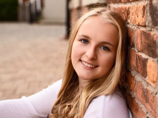 a person leaning against a brick wall