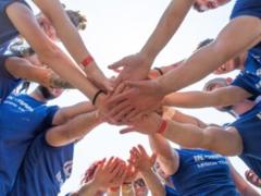 a group of people putting their hands together