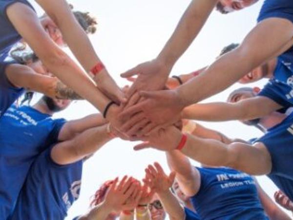 a group of people putting their hands together