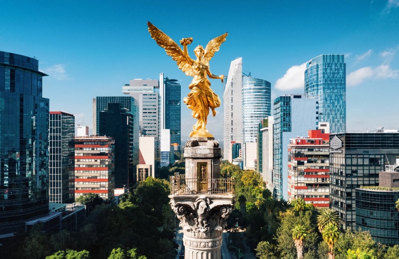 a statue of a person with wings and a city in the background