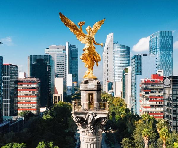 a statue of a person with wings and a city in the background
