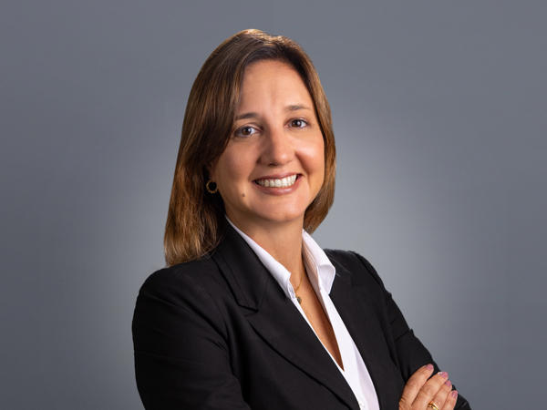 a person in a suit with her arms crossed