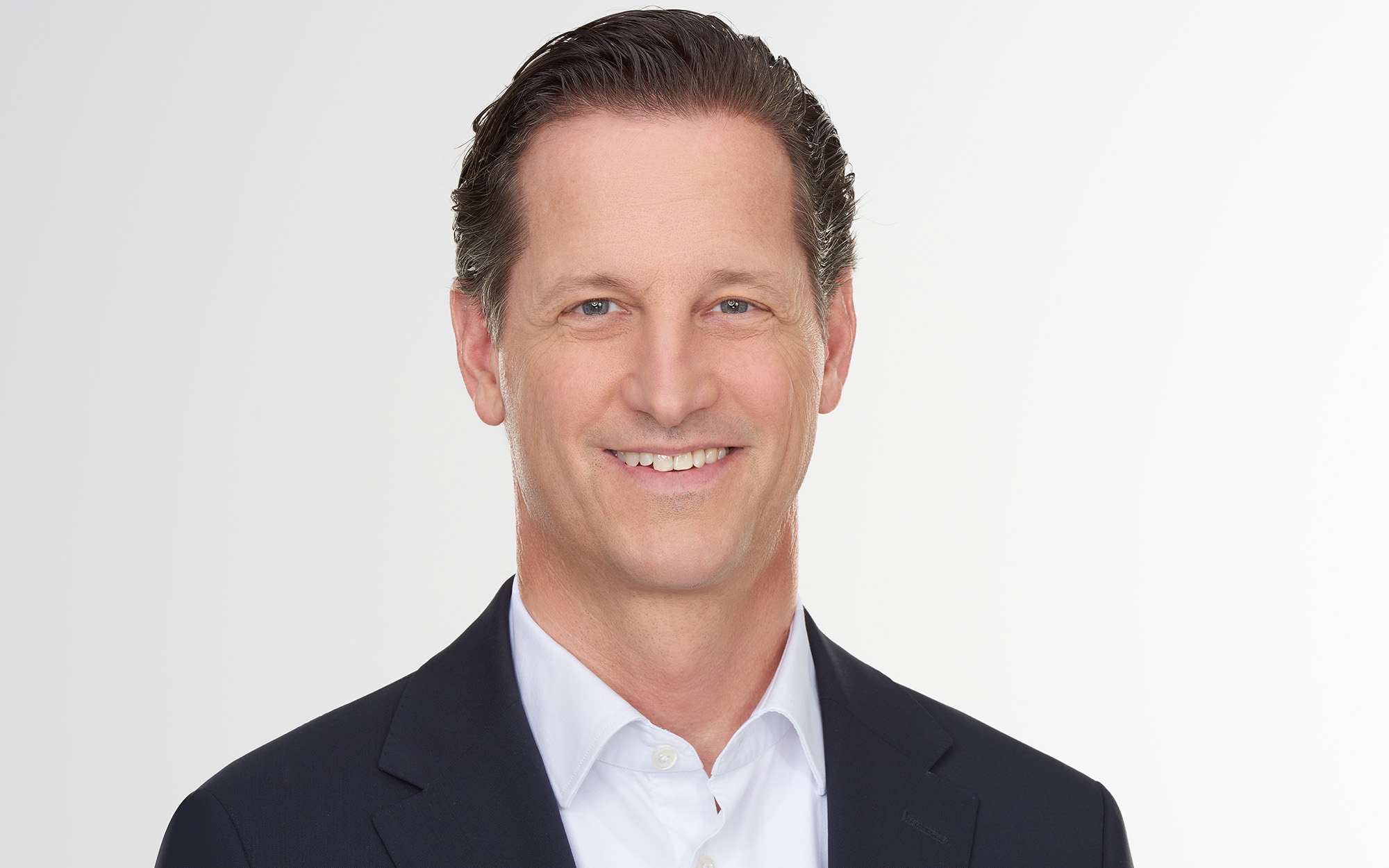 a person in a suit smiling