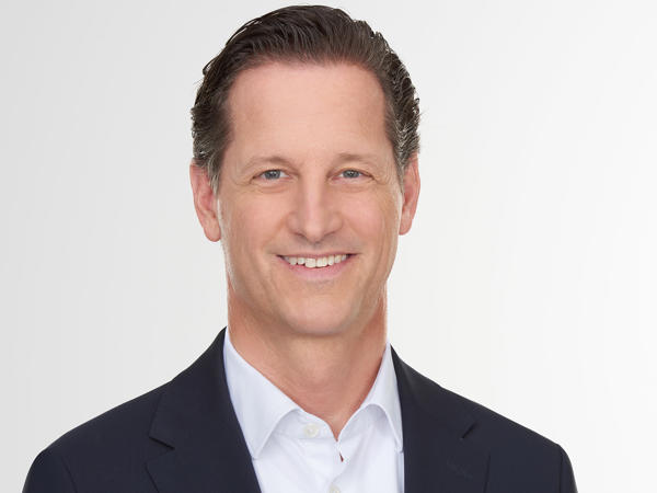 a person in a suit smiling