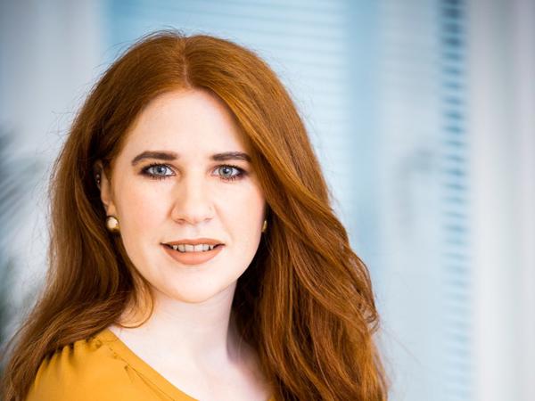 a person with red hair and a yellow shirt