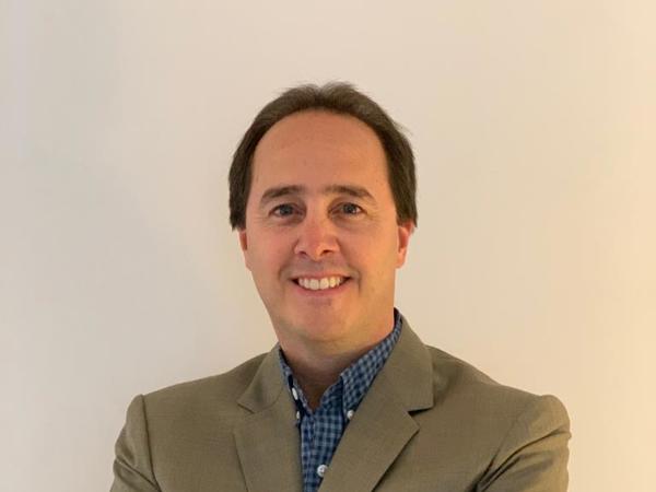 a person in a suit with his arms crossed