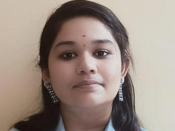 a person with long hair and earrings