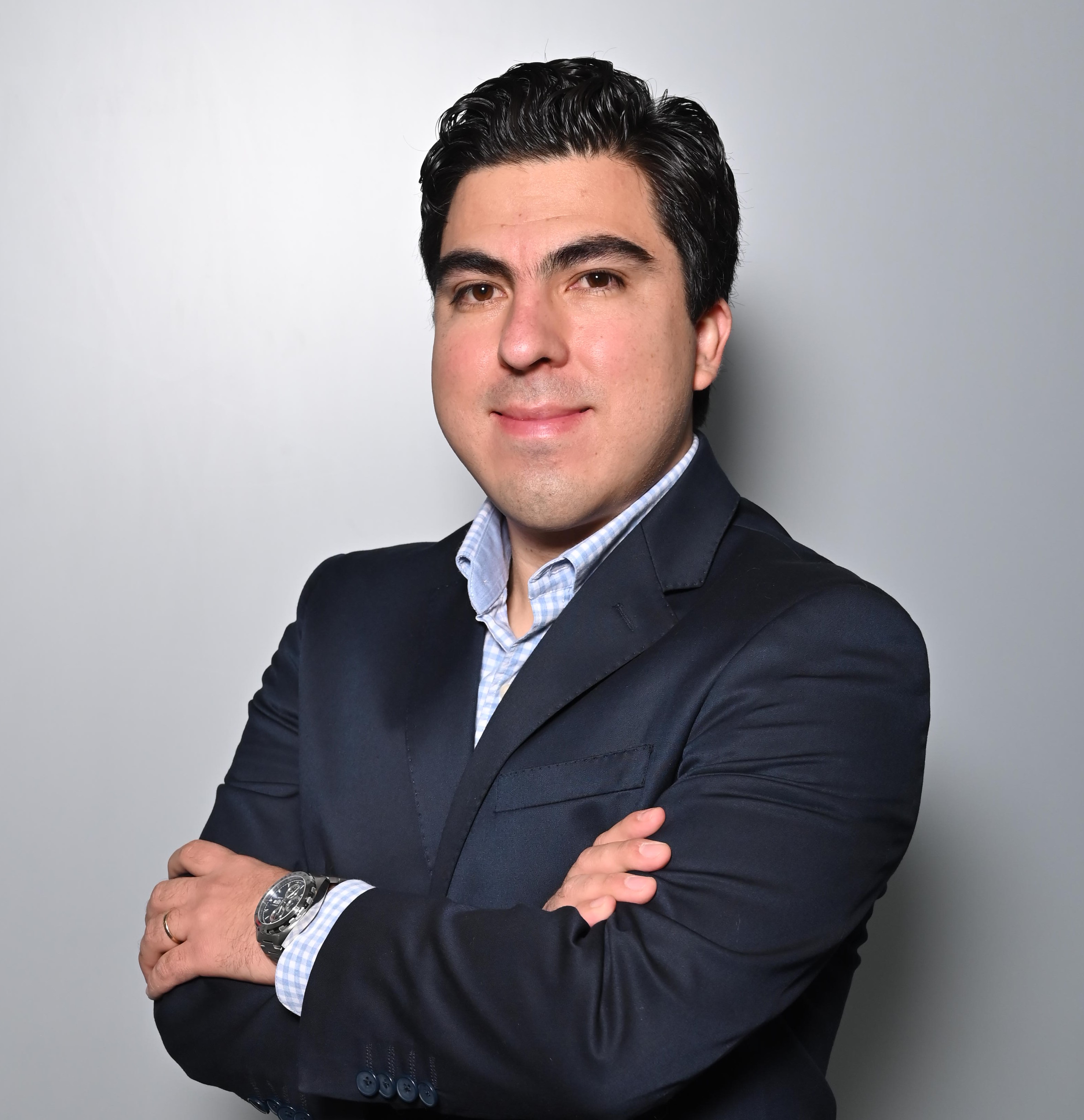 a person in a suit with his arms crossed