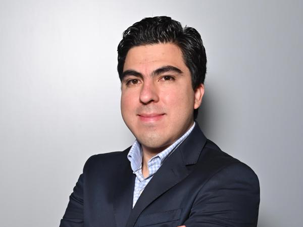 a person in a suit with his arms crossed