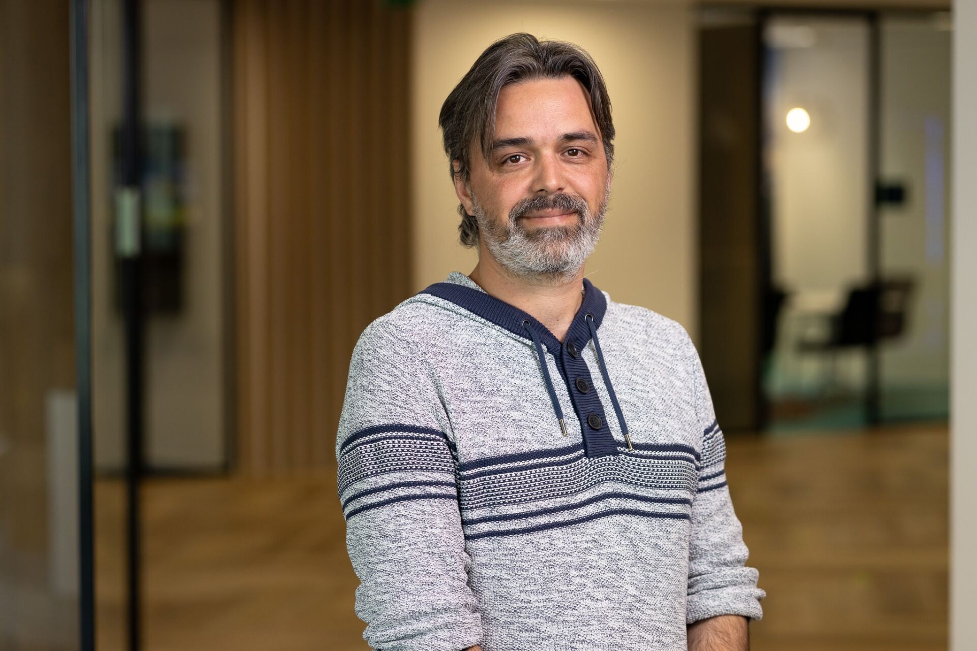a person with grey beard and mustache wearing a sweater