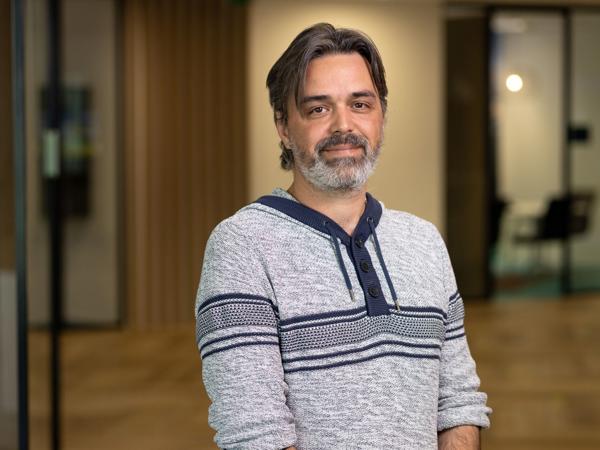 a person with grey beard and mustache wearing a sweater