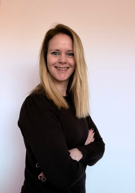 a person with blonde hair wearing a black shirt