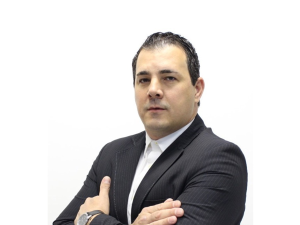 a person in a suit with his arms crossed