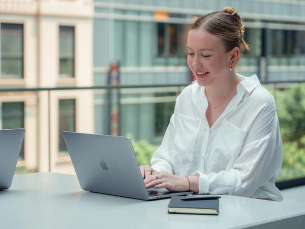 a person sitting at a table with a laptop