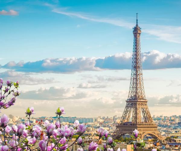 a tower with flowers in front of it