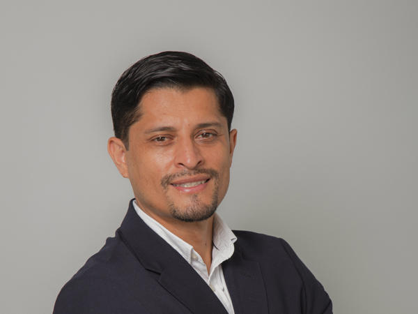a person in a suit with his arms crossed