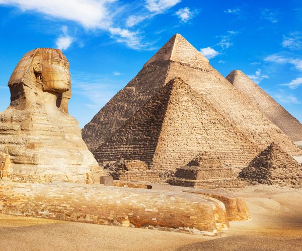 a group of pyramids and a sphinx