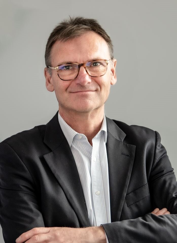 a person in a suit and glasses
